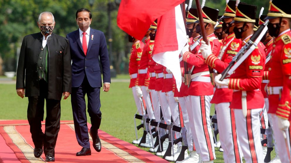 East Timorese President Jose Ramos Horta, left, accompanied by Indonesian President Joko Widodo inspects an honor guard upon his arrival at the Presidential Palace in Bogor, West Java, Indonesia, Tuesday, July 19, 2022. (Adi Weda/ Pool Photo via AP)